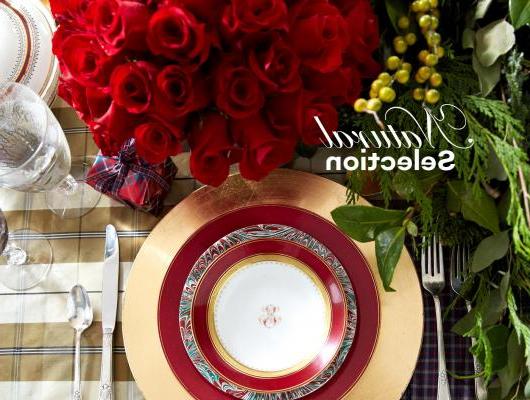 Holiday place setting with greenery and roses